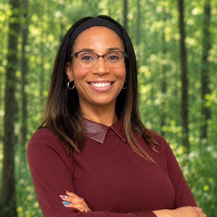 Kristine Raveau Headshot in front of woods